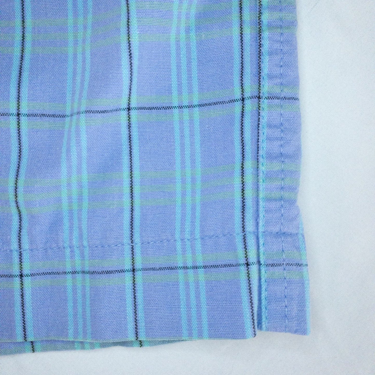 Levis Dockers purple plaid women's shorts laid flat showing front, side pockets, waistband details, and small wear dot image 6