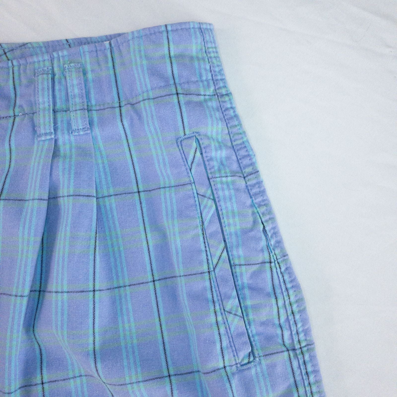 Levis Dockers purple plaid women's shorts laid flat showing front, side pockets, waistband details, and small wear dot image 3