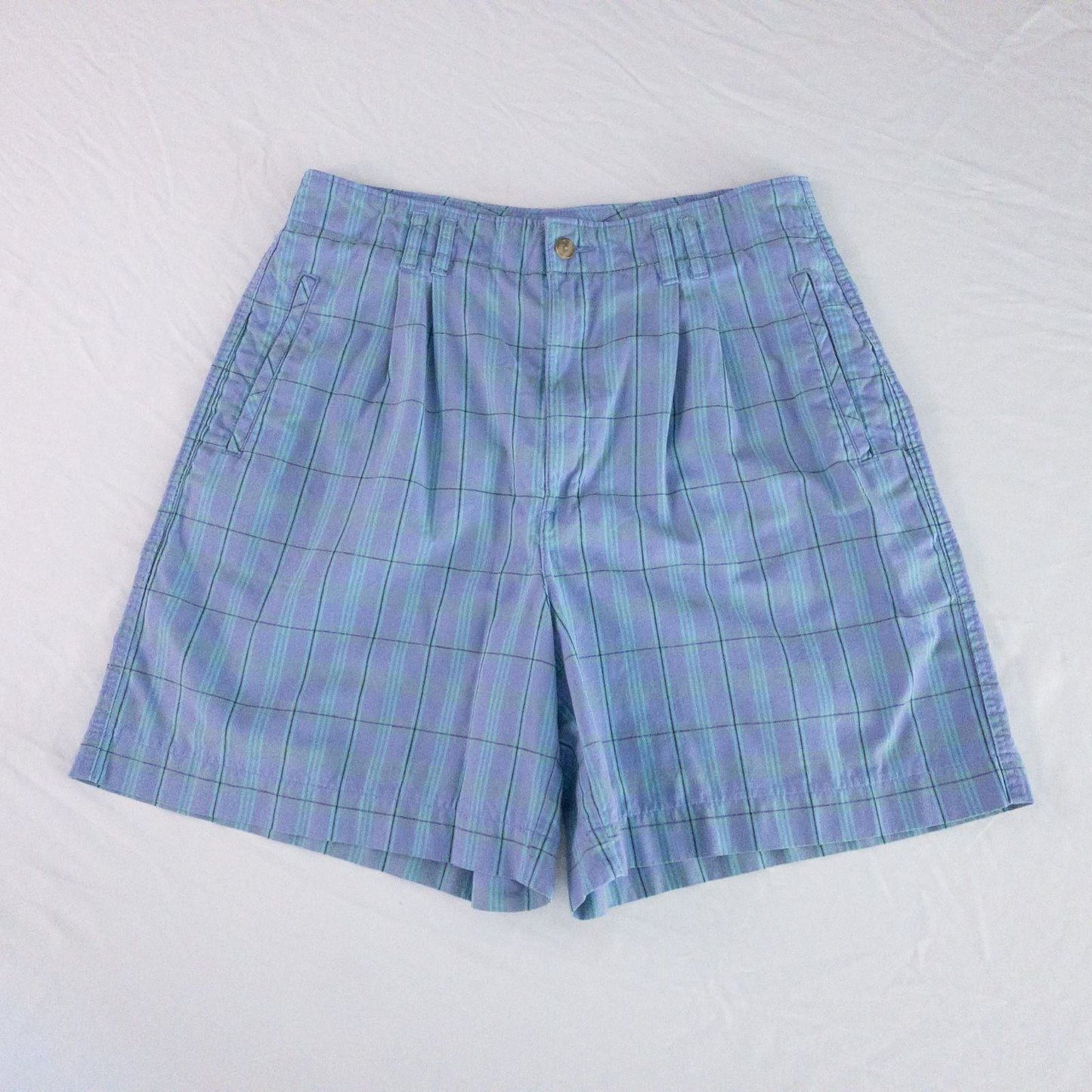 Levis Dockers purple plaid women's shorts laid flat showing front, side pockets, waistband details, and small wear dot