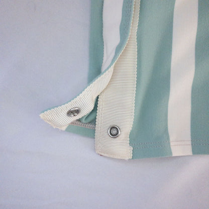 Lululemon striped neckwarmer scarf in white pink green tones displayed on a white mannequin head and laid flat showing snap closure image 8