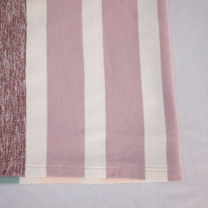 Lululemon striped neckwarmer scarf in white pink green tones displayed on a white mannequin head and laid flat showing snap closure image 5