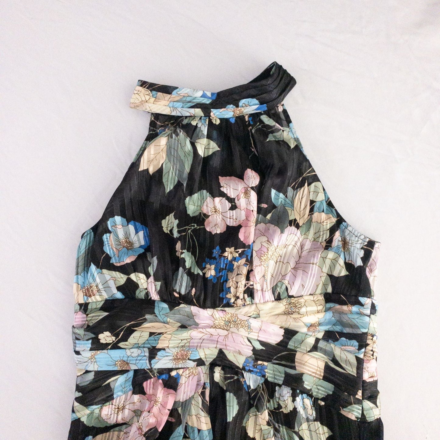 Adrianna Papell black floral maxi dress with twisted front detail hanging on clear hanger in front of white background image 3