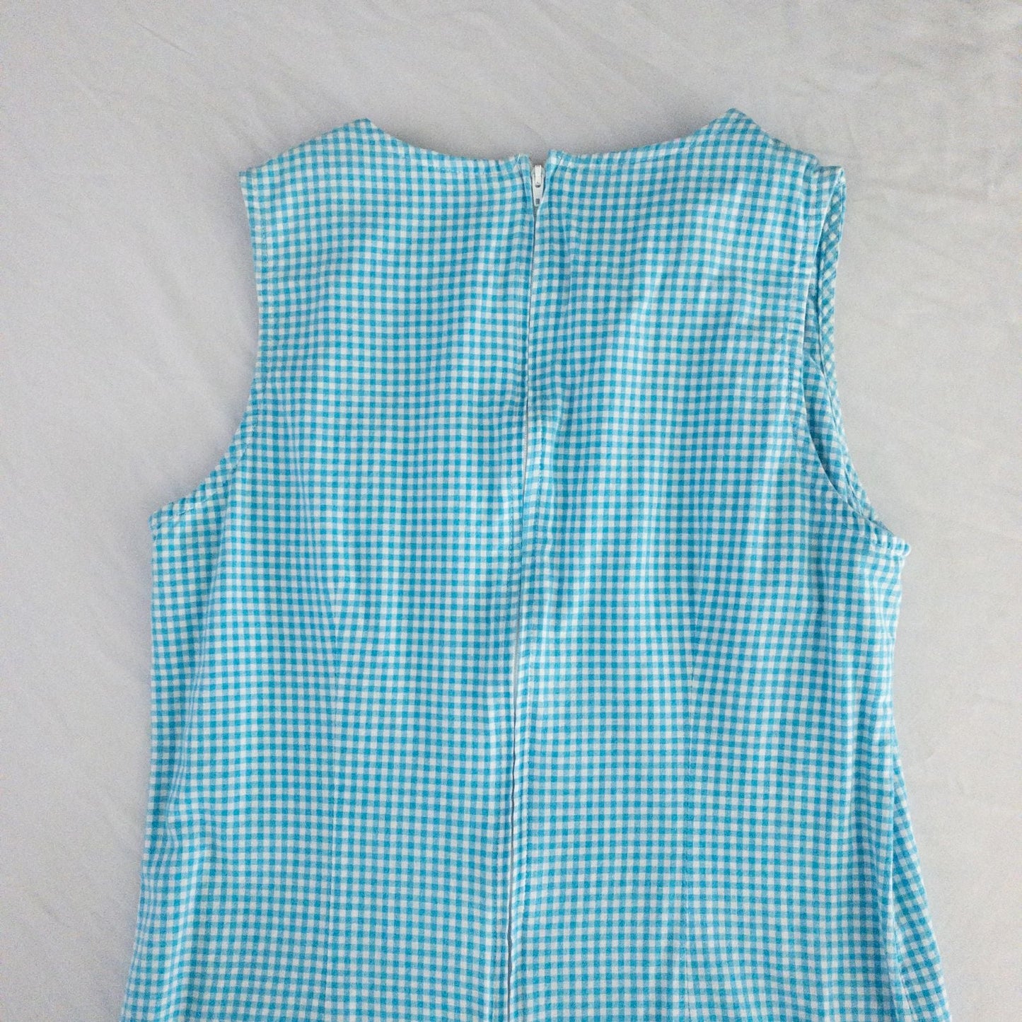 Faded Glory vintage blue and white gingham sleeveless dress with v-neck and back zipper on clear hanger against white background image 7