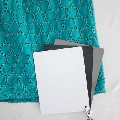Old Navy teal green doily pattern sleeveless summer dress with gathered waist and concealed back zipper hanging on a clear hanger against a white cloth background image 8