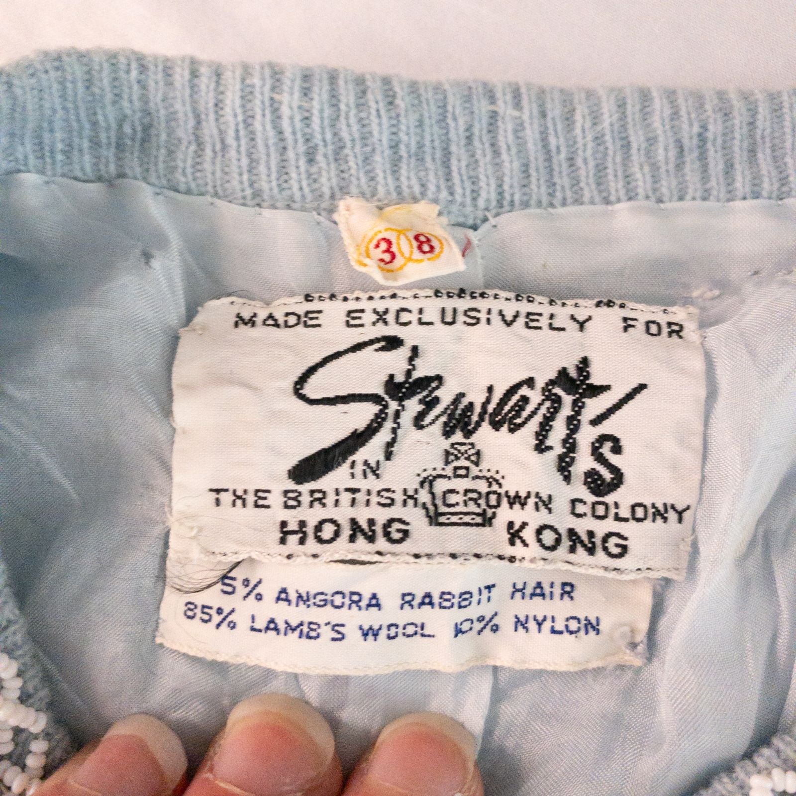 Stewarts pastel blue vintage cardigan with white bead floral embellishments and pearl buttons on a hanger image 15