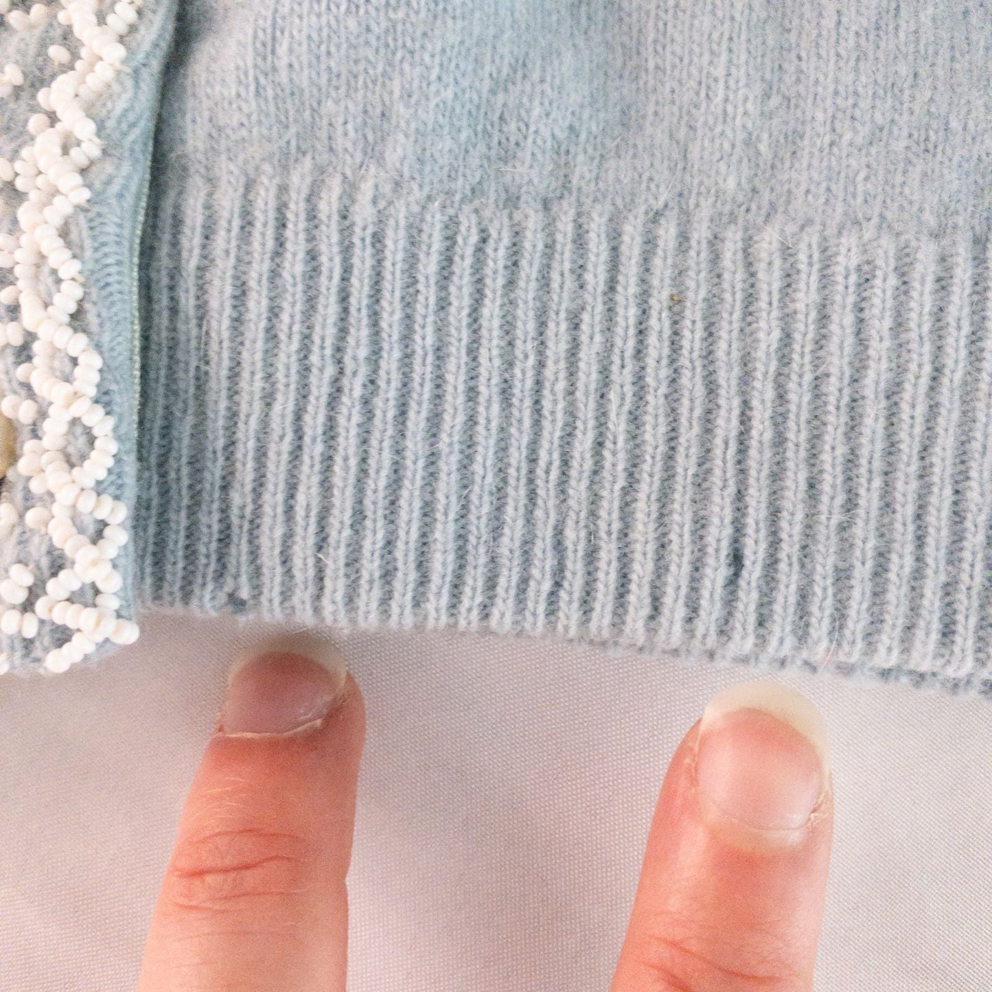 Stewarts pastel blue vintage cardigan with white bead floral embellishments and pearl buttons on a hanger image 7