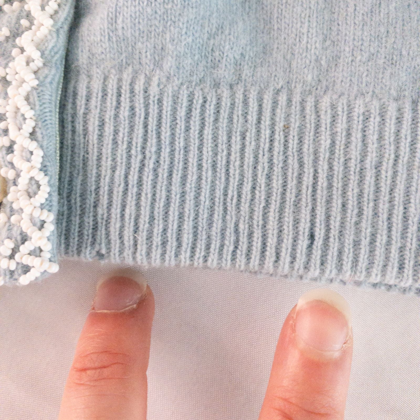 Stewarts pastel blue vintage cardigan with white bead floral embellishments and pearl buttons on a hanger image 7