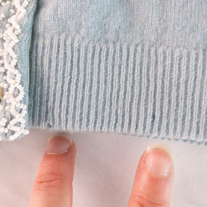 Stewarts pastel blue vintage cardigan with white bead floral embellishments and pearl buttons on a hanger image 7