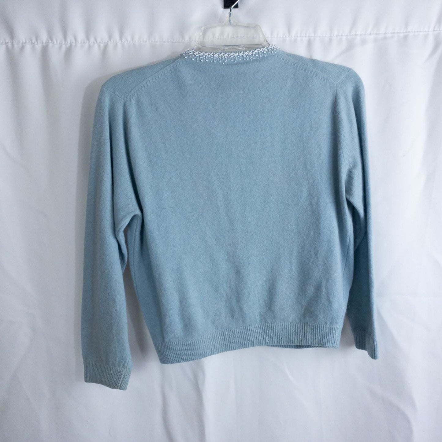 Stewarts pastel blue vintage cardigan with white bead floral embellishments and pearl buttons on a hanger image 12