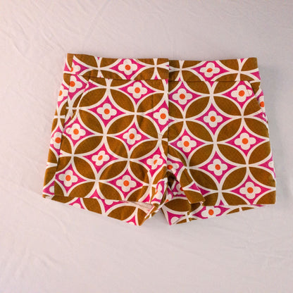 Trina Turk brown floral short shorts for women laid flat with visible tags and zipper hook closure