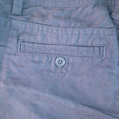 Calvin Klein blue linen shorts for women, size 4, with button closure and belt loops, front and back pockets, shown laid flat. image 7