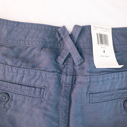 Calvin Klein blue linen shorts for women, size 4, with button closure and belt loops, front and back pockets, shown laid flat. image 8
