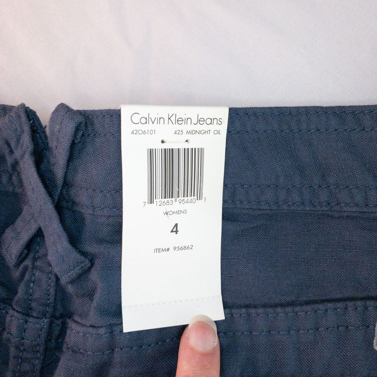 Calvin Klein blue linen shorts for women, size 4, with button closure and belt loops, front and back pockets, shown laid flat. image 12
