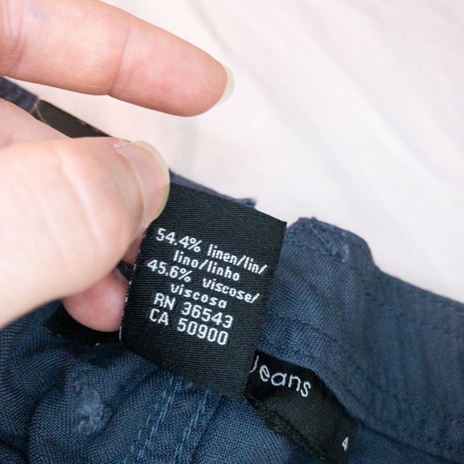 Calvin Klein blue linen shorts for women, size 4, with button closure and belt loops, front and back pockets, shown laid flat. image 10