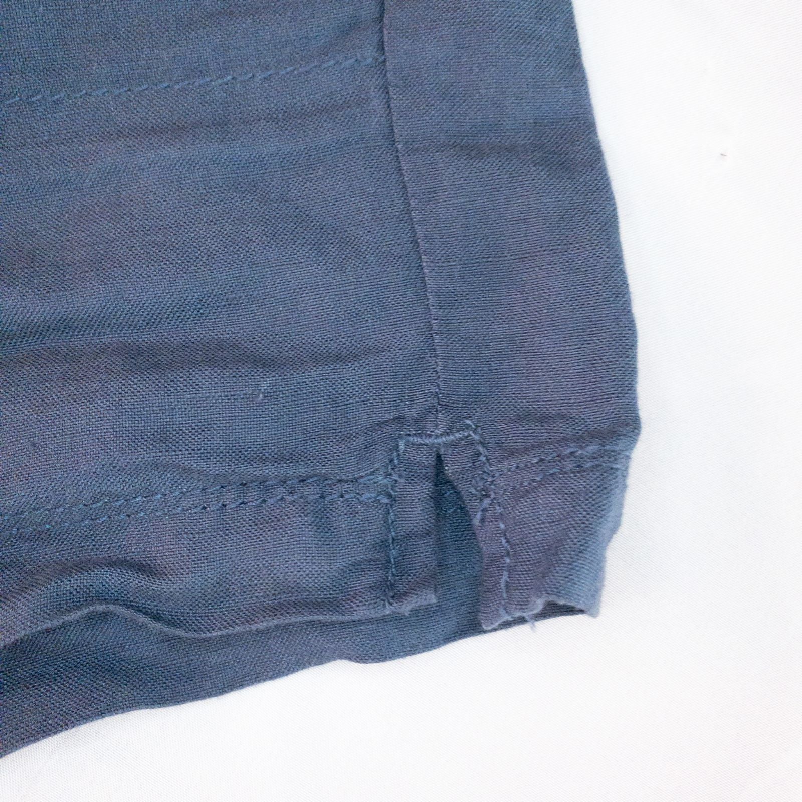 Calvin Klein blue linen shorts for women, size 4, with button closure and belt loops, front and back pockets, shown laid flat. image 5