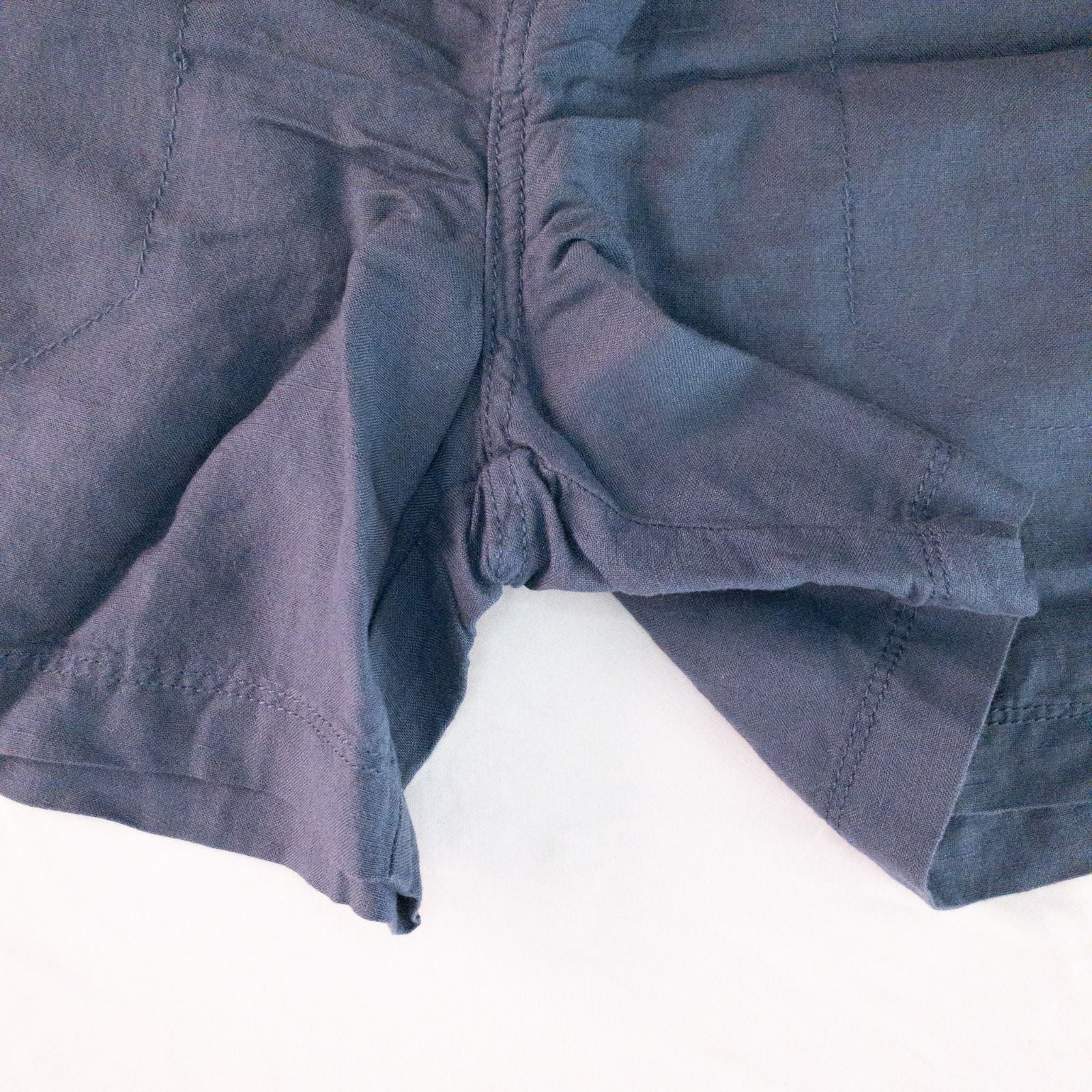 Calvin Klein blue linen shorts for women, size 4, with button closure and belt loops, front and back pockets, shown laid flat. image 4