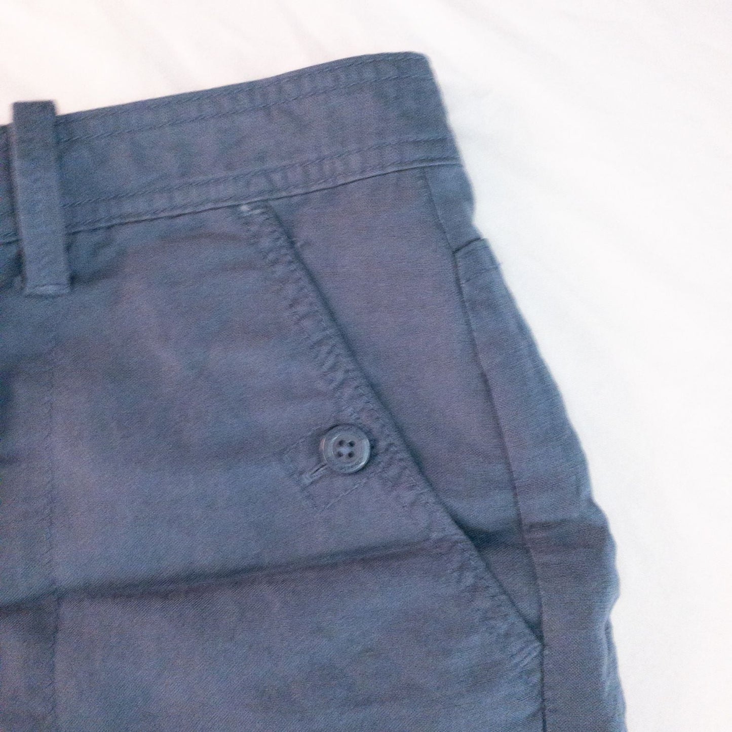 Calvin Klein blue linen shorts for women, size 4, with button closure and belt loops, front and back pockets, shown laid flat. image 3
