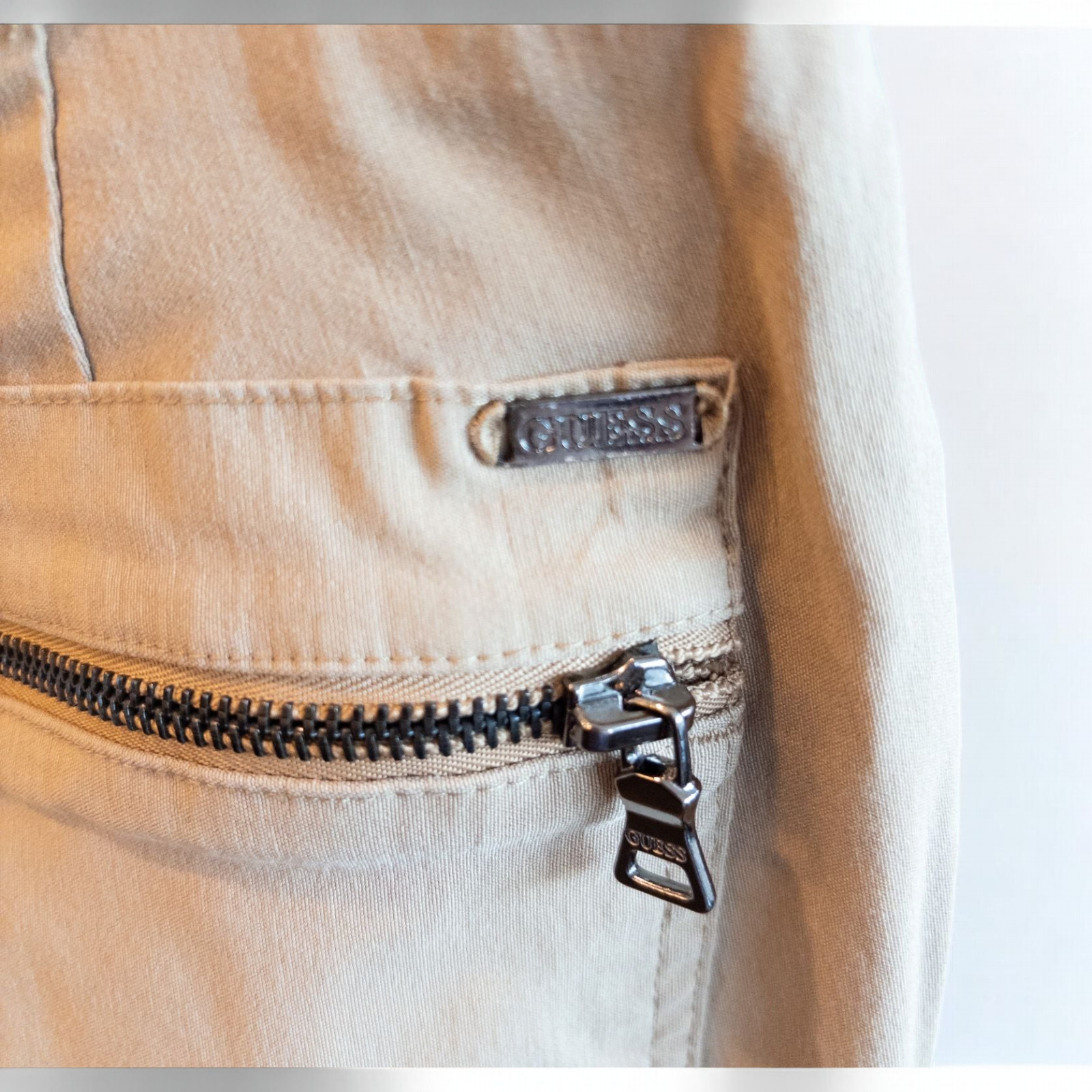 Guess vintage Y2K khaki flare pants with zippered pockets and relaxed fit hanging on a hanger image 5