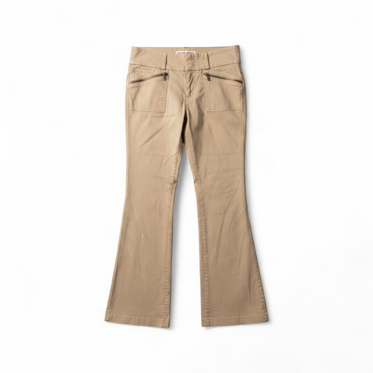 Guess vintage Y2K khaki flare pants with zippered pockets and relaxed fit hanging on a hanger front on white muslin photography backdrop