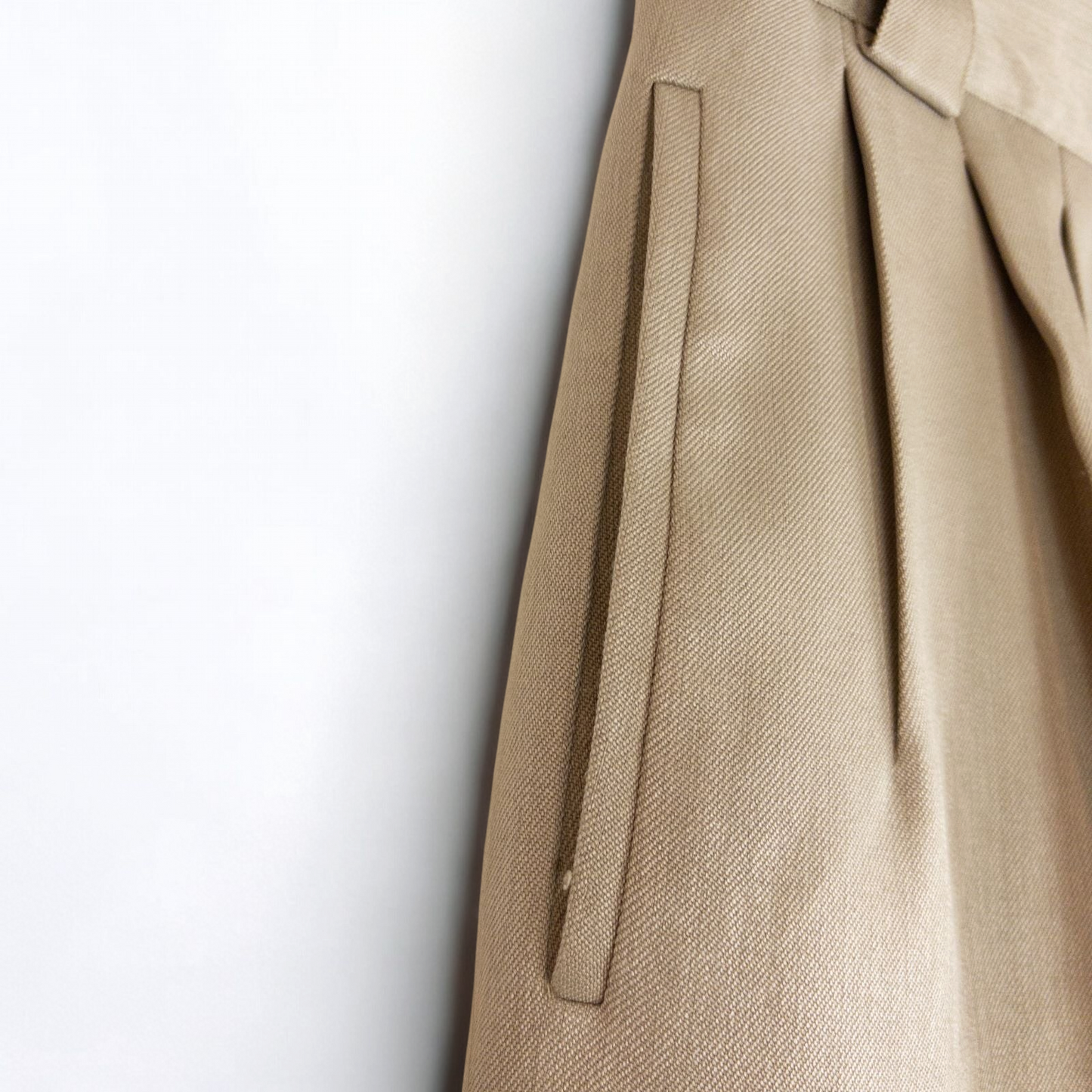 Giorgio Sant Angelo tan vintage pants with front pleats and dual button closure hanging on hanger image 4