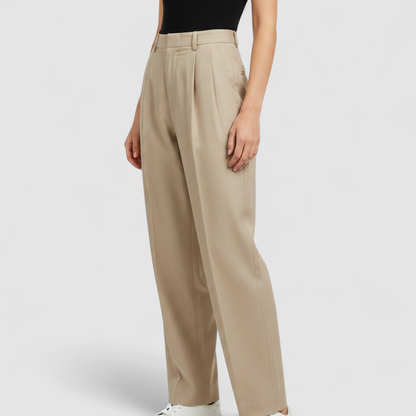 Giorgio Sant Angelo tan vintage pants with front pleats and dual button closure hanging on hanger on model