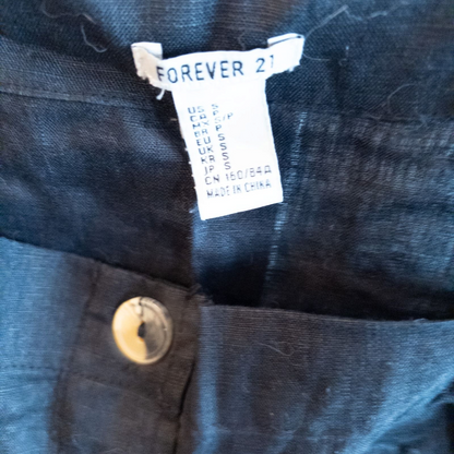 Forever 21 black linen dress with button front and adjustable straps hanging on a white hanger image 7