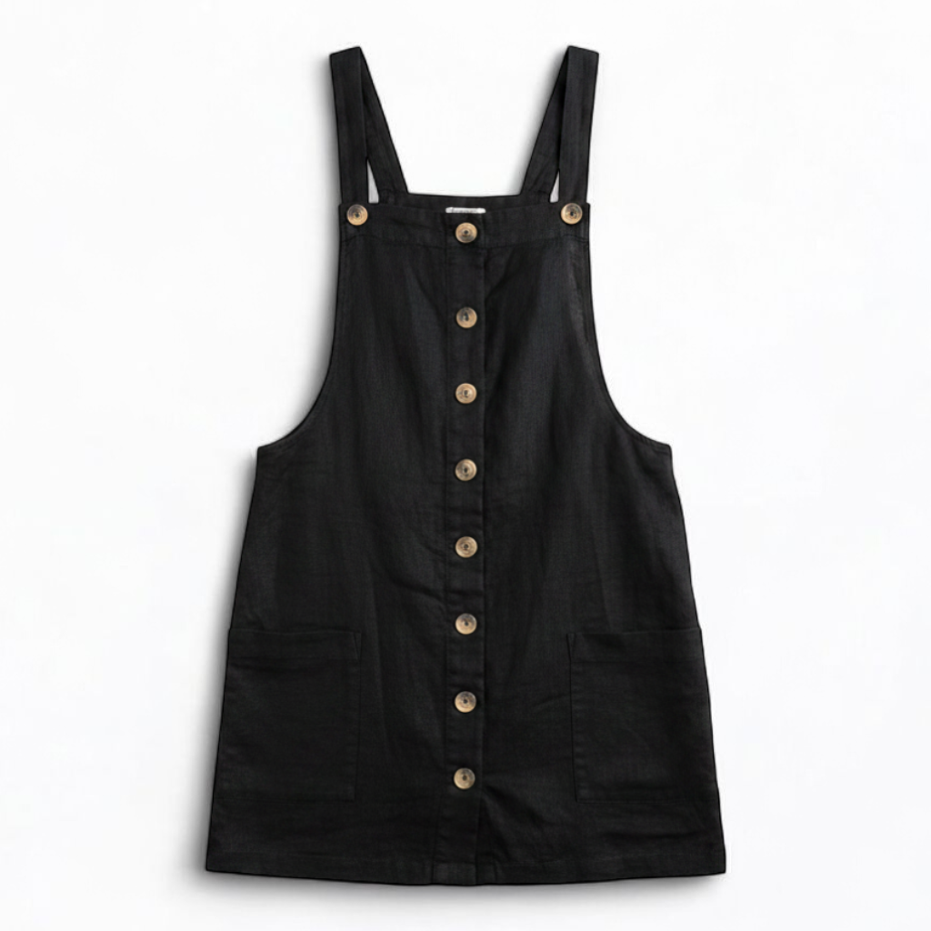 Forever 21 black linen dress with button front and adjustable straps hanging on a white hanger front on white muslin photography backdrop