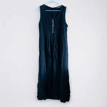 Sweet Jessie black denim long sleeveless dress with front decorative buttons and back button closure hanging on a hanger in front of a bookshelf and mirror image 2