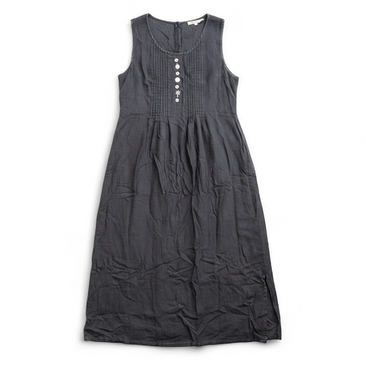 Sweet Jessie black denim long sleeveless dress with front decorative buttons and back button closure hanging on a hanger in front of a bookshelf and mirror front on white muslin photography backdrop