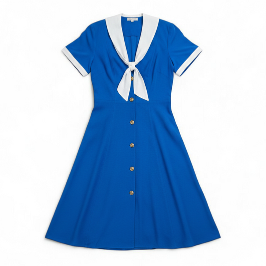 Piccalino vintage blue long sailor dress with white collar and cuff accents, button front, and short sleeves laid flat. front on white muslin photography backdrop