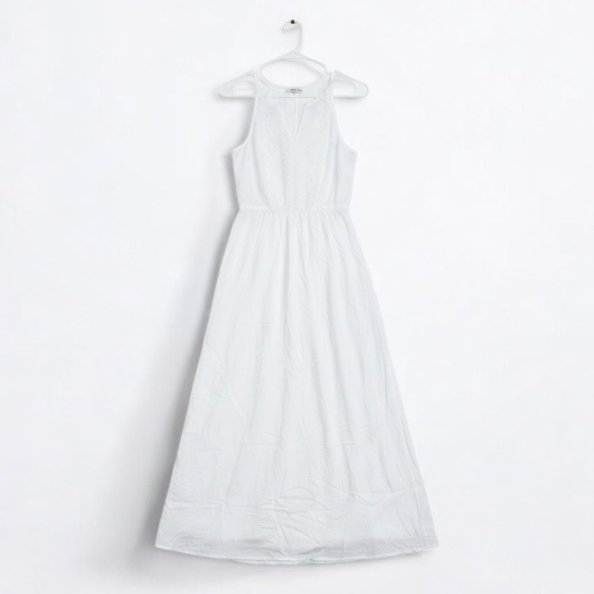 Old Navy long white sleeveless lace maxi dress hanging on hanger in room front on white muslin photography backdrop