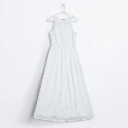 Old Navy long white sleeveless lace maxi dress hanging on hanger in room front on white muslin photography backdrop