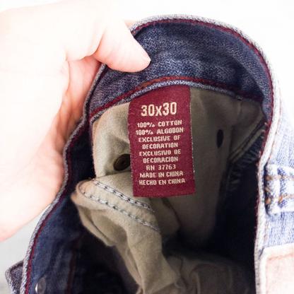 Perry Ellis women's blue denim jeans with five pockets hanging on a hanger front and back views image 11