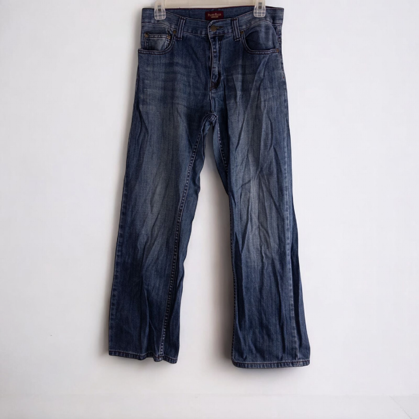 Perry Ellis women's blue denim jeans with five pockets hanging on a hanger front and back views