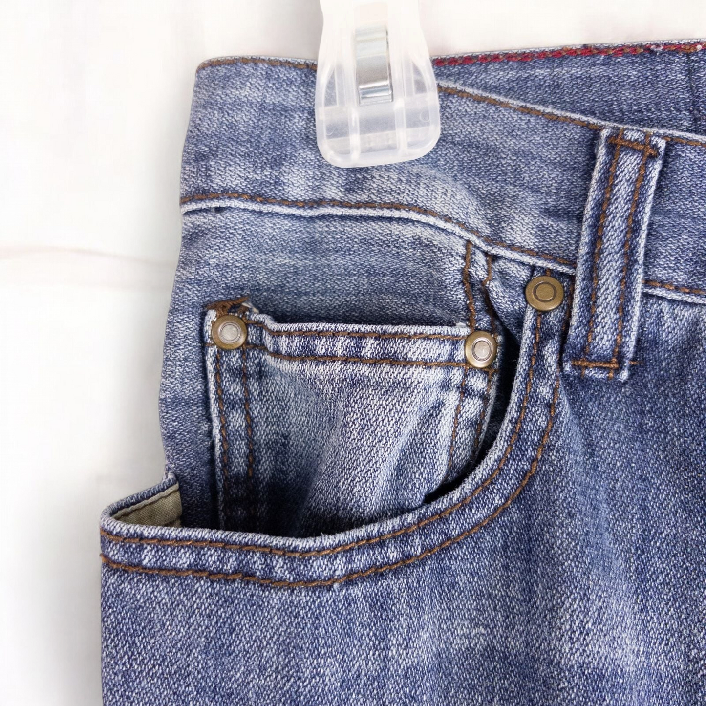Perry Ellis women's blue denim jeans with five pockets hanging on a hanger front and back views image 3