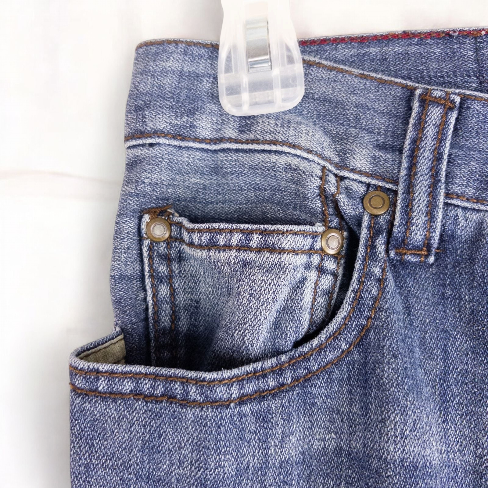 Perry Ellis women's blue denim jeans with five pockets hanging on a hanger front and back views image 3