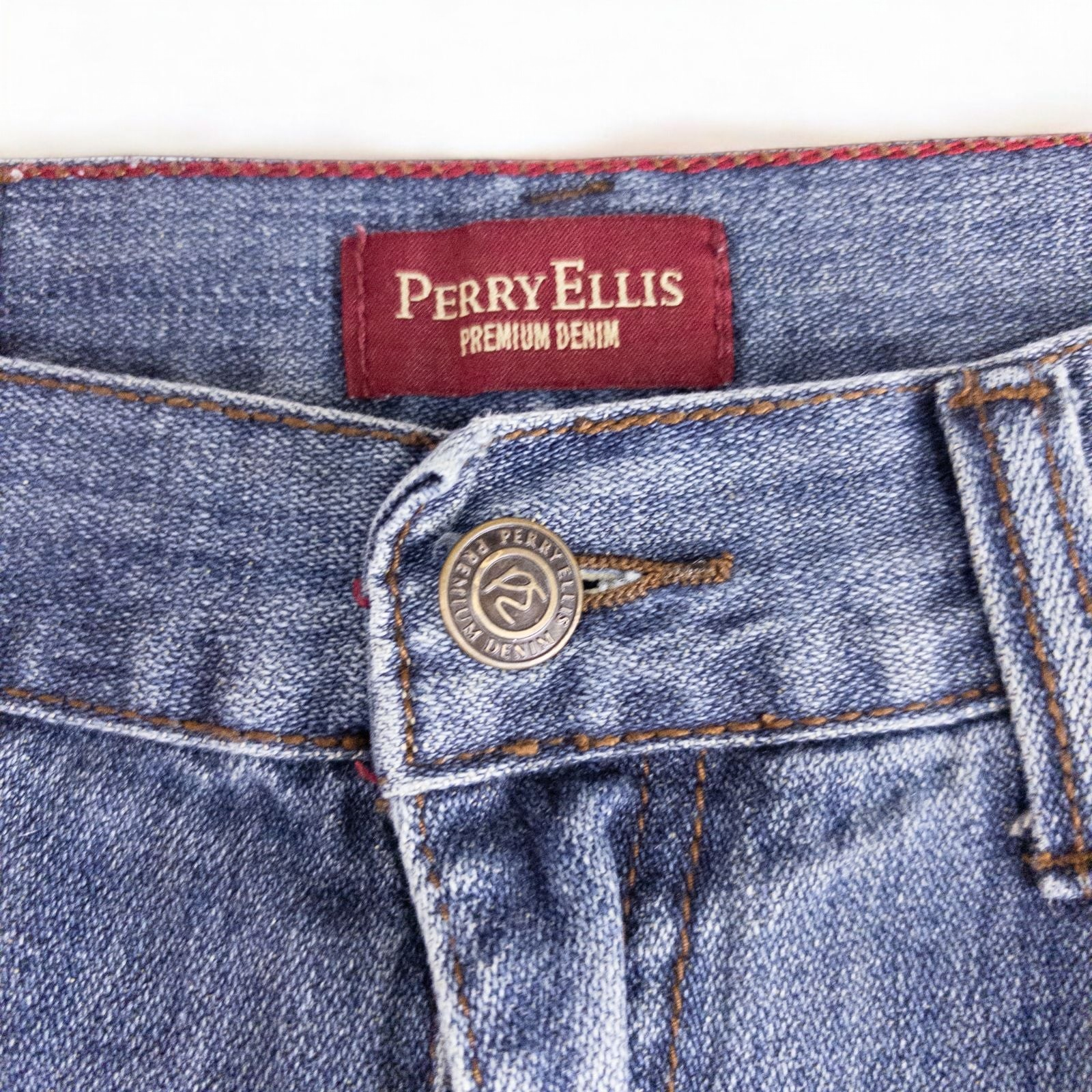 Perry Ellis women's blue denim jeans with five pockets hanging on a hanger front and back views image 4