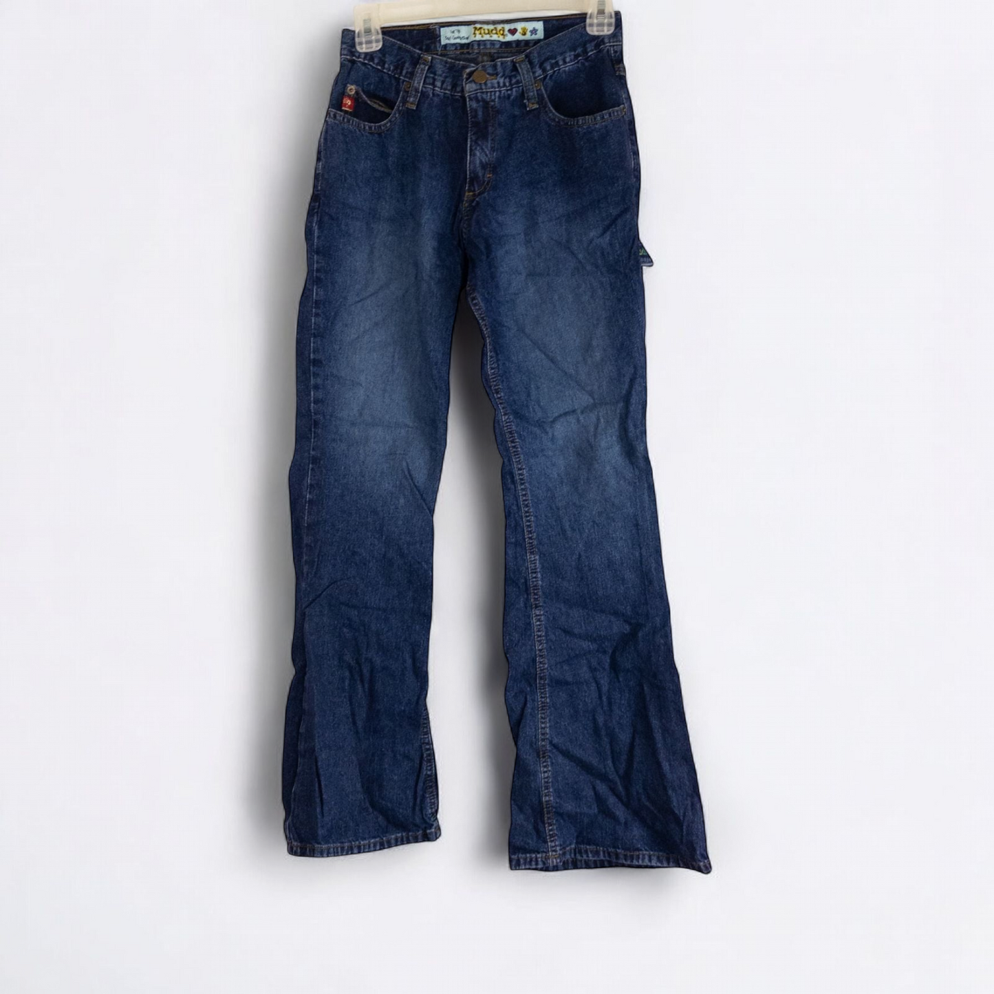 Vintage 1990s Mudd blue denim jeans with button closure hanging on hanger front view