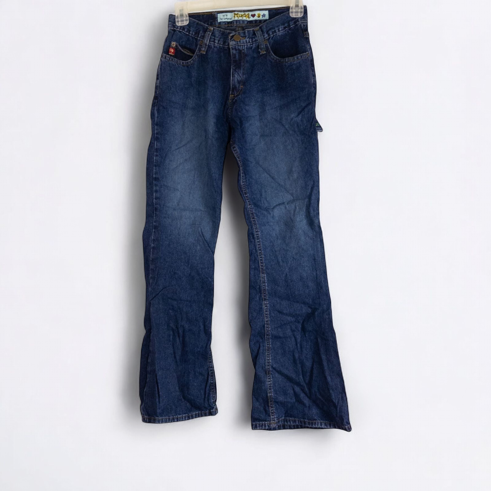 Vintage 1990s Mudd blue denim jeans with button closure hanging on hanger front view
