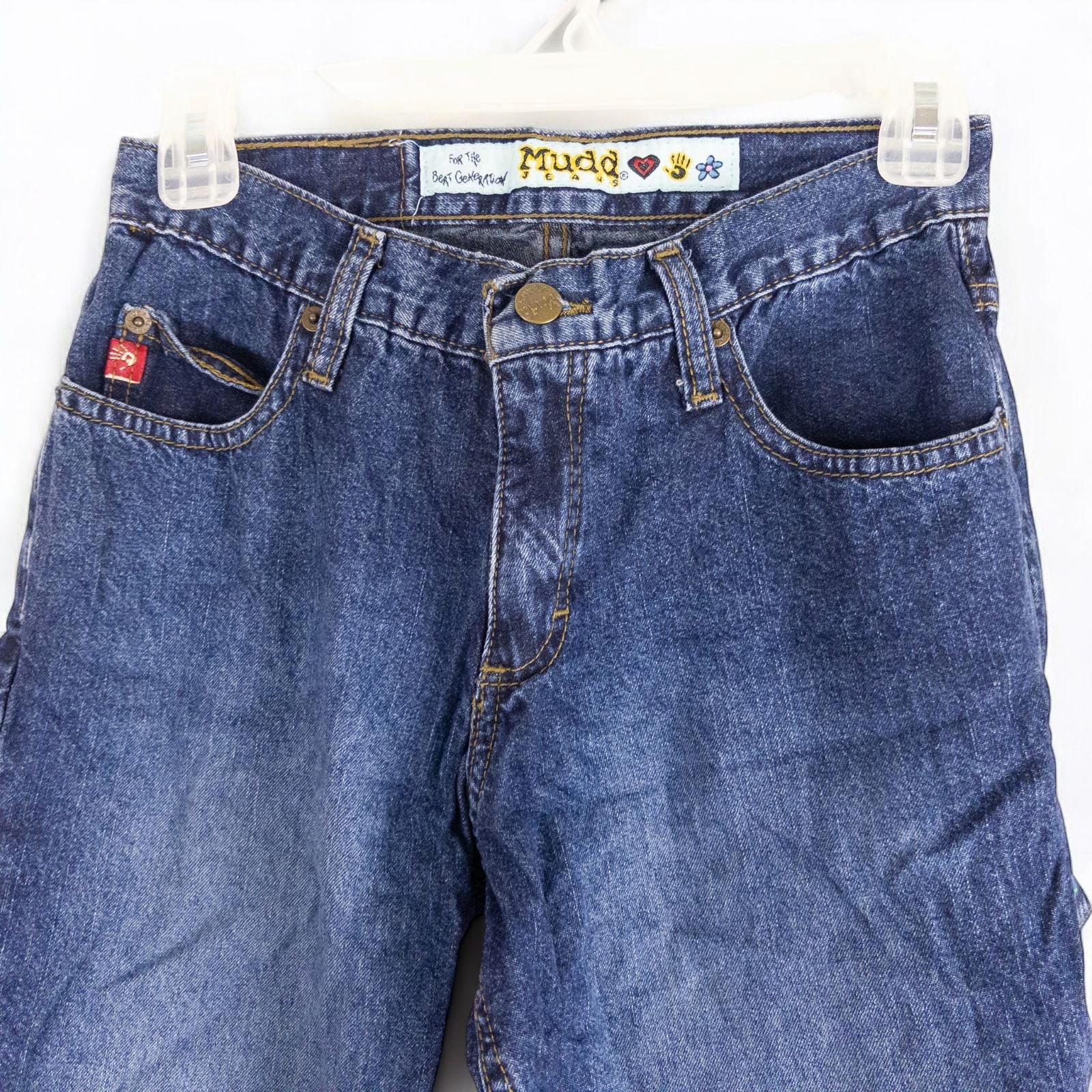 Vintage 1990s Mudd blue denim jeans with button closure hanging on hanger front view image 2