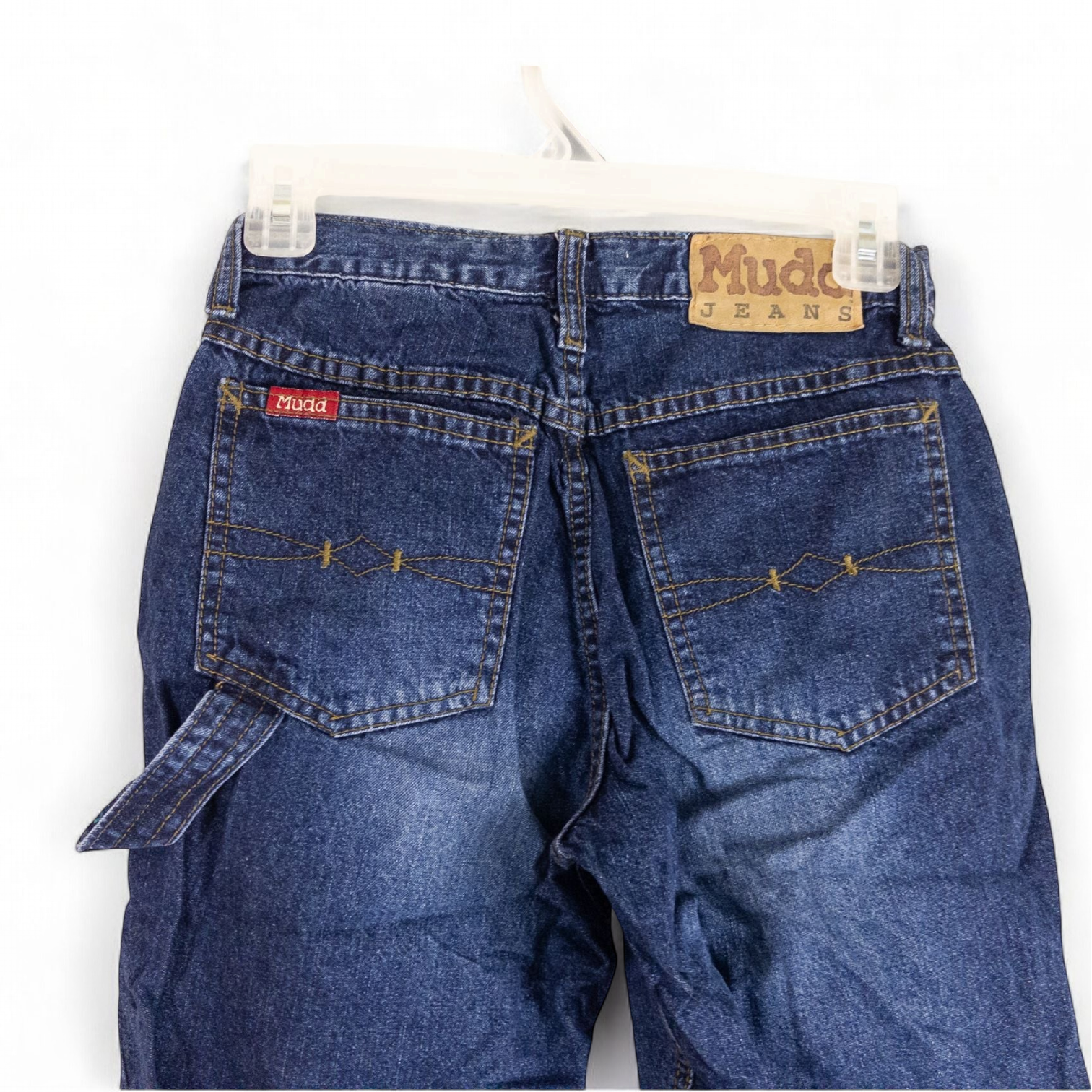 Vintage 1990s Mudd blue denim jeans with button closure hanging on hanger front view image 5