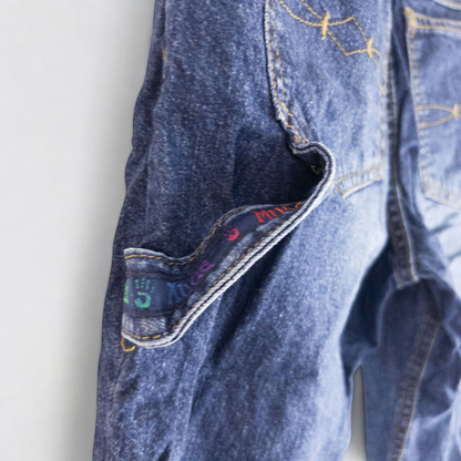 Vintage 1990s Mudd blue denim jeans with button closure hanging on hanger front view image 6