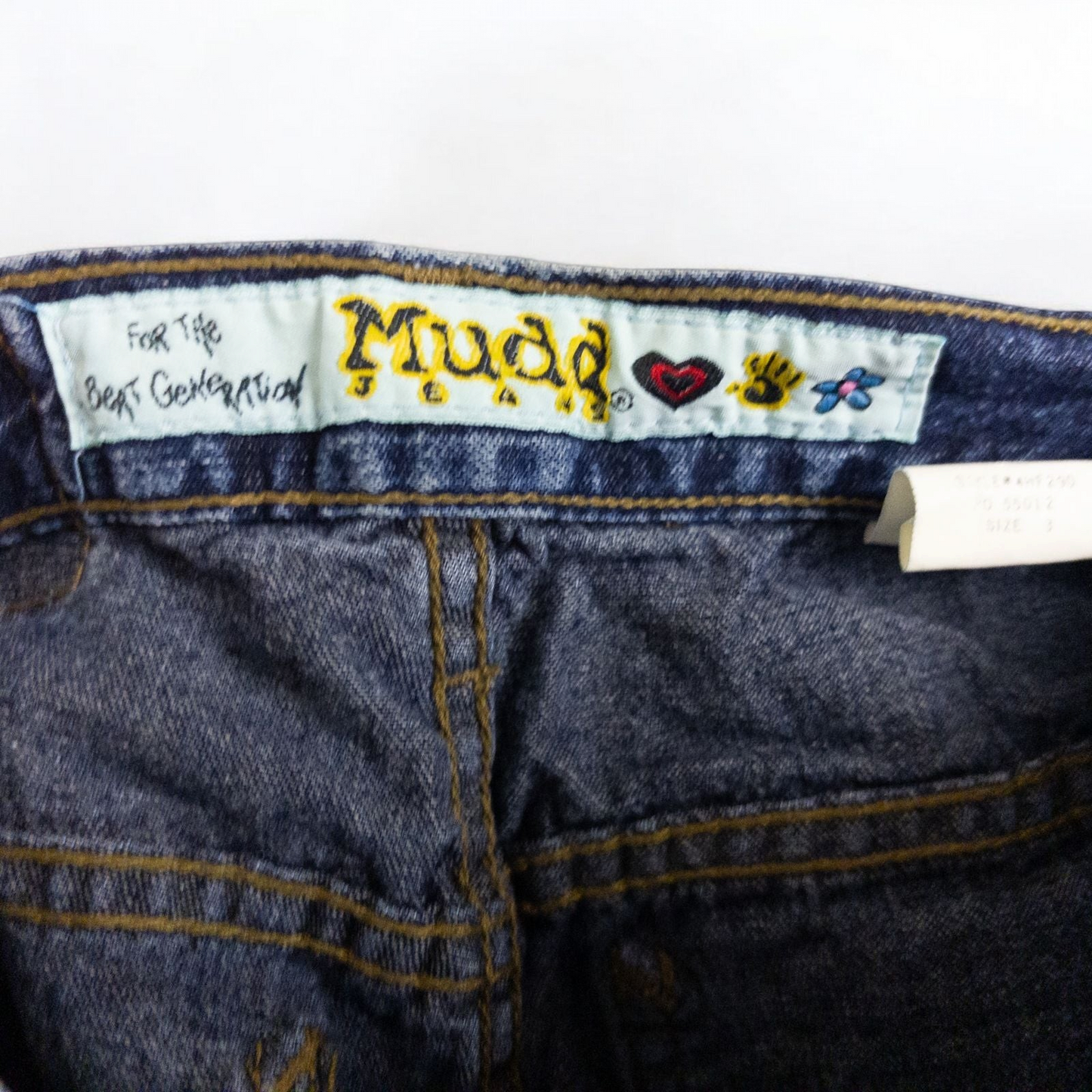 Vintage 1990s Mudd blue denim jeans with button closure hanging on hanger front view image 8