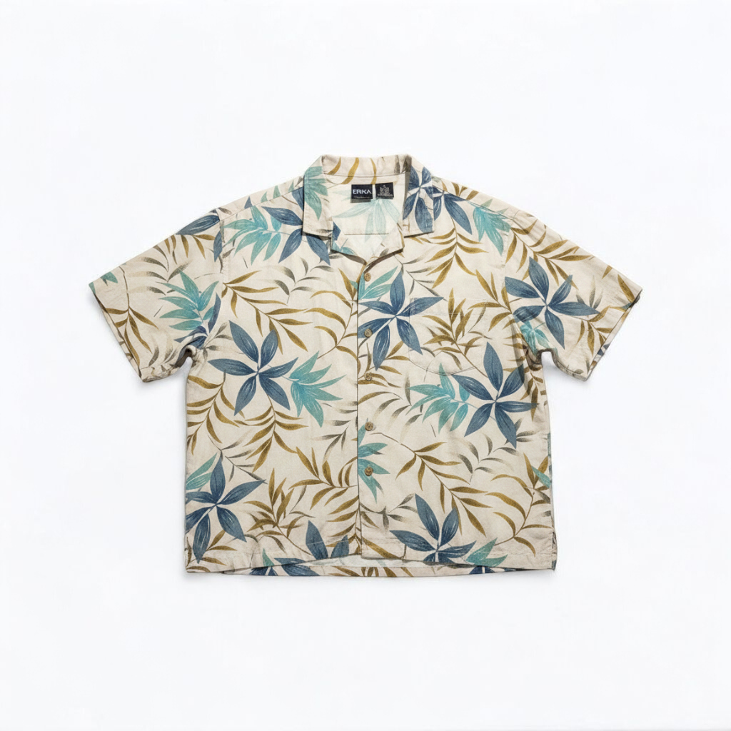 Erika vintage unisex Hawaiian shirt in cream with brown and blue leaf pattern, short sleeves and button front front on white muslin photography backdrop