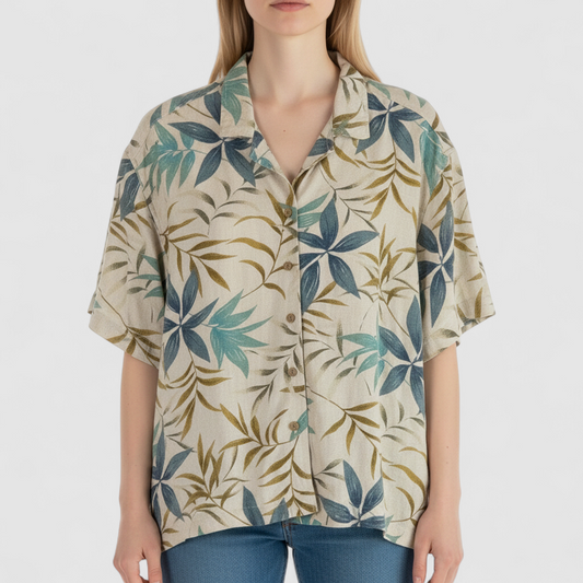 Erika vintage unisex Hawaiian shirt in cream with brown and blue leaf pattern, short sleeves and button front on model
