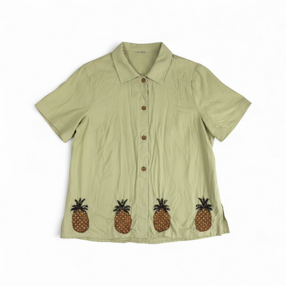 Vintage beaded pineapple linen short sleeve shirt in muted green with wooden buttons and detailed beadwork on pineapples front on white muslin photography backdrop