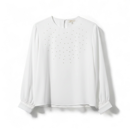 Anne Kriste vintage white sheer blouse with pearl beading on front and long sleeves with button cuffs hanging on hanger front on white muslin photography backdrop