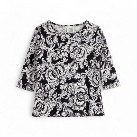 JM Collection black and white floral blouse top with 3/4 sleeves and crew neck, women's medium petite size front on white muslin photography backdrop
