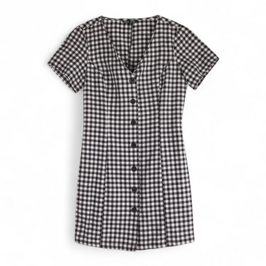 Shein black and white checkered tunic mini dress with button front and short sleeves front on white muslin photography backdrop