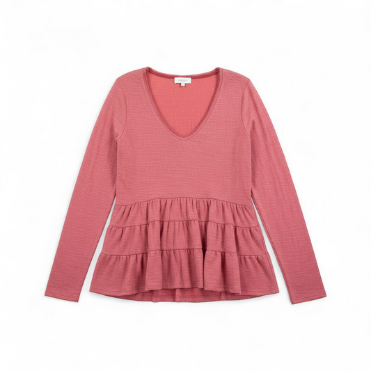 Anthropologie Deletta pink tiered ruffle long sleeve top with v-neckline and textured knit fabric front on white muslin photography backdrop